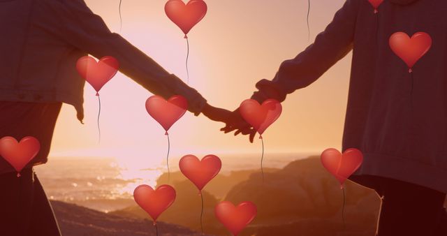 Couple holding hands while standing at a sunset beach, with heart-shaped balloons symbolizing love and romance. Ideal for Valentine's Day content, romantic occasions, relationship blogs, and greeting cards.