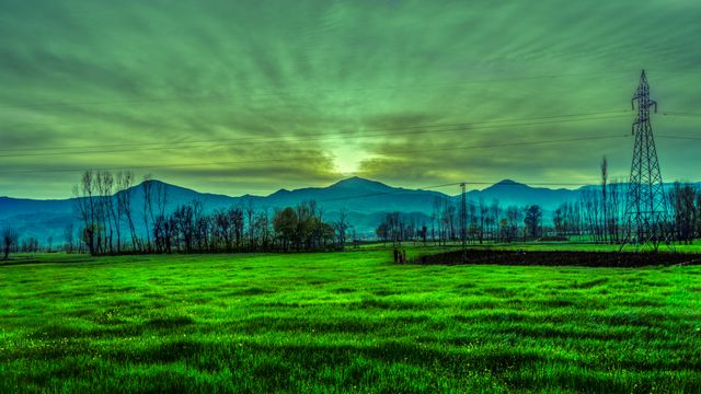 Sunset over Rural Landscape with Green Field Grass and Mountains - Download Free Stock Photos Pikwizard.com