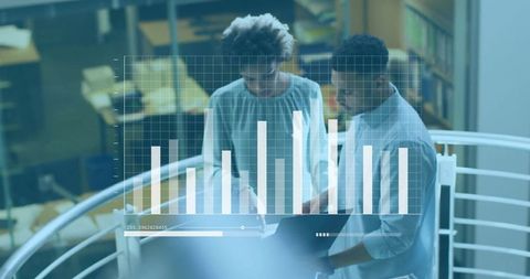 Colleagues Analyzing Data Chart on Upper-Level Workspace
