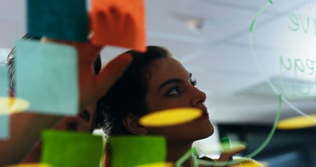 Team brainstorming with colorful post-it notes on glass wall - Download Free Stock Images Pikwizard.com