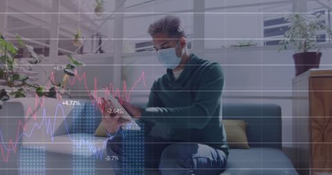 Masked Man Analyzing Digital Data on Tablet During COVID-19 Pandemic