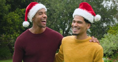 Diverse Friends Laughing in Santa Hats Holiday Joy