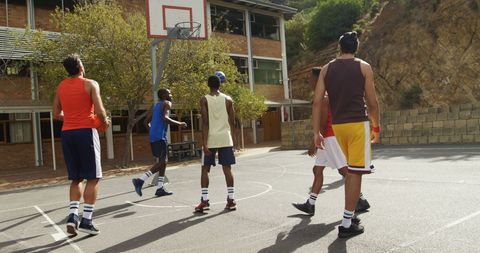 Young basketball players practicing on outdoor court