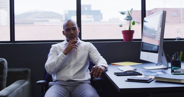 Pensive Businessman Sitting in Modern Office Near Window - Download Free Stock Images Pikwizard.com