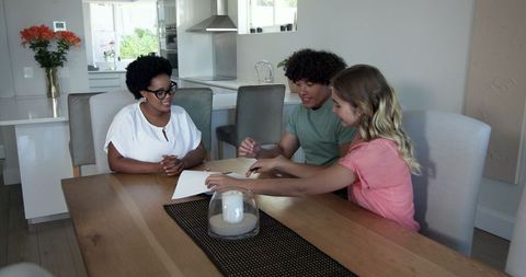 Couple receiving house keys from real estate agent in modern interior