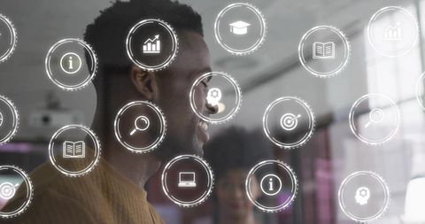 Black professional smiling while using translucent digital analytics and teamwork interface