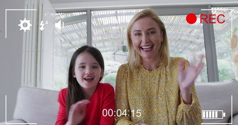 Mother and daughter smiling during video call interaction