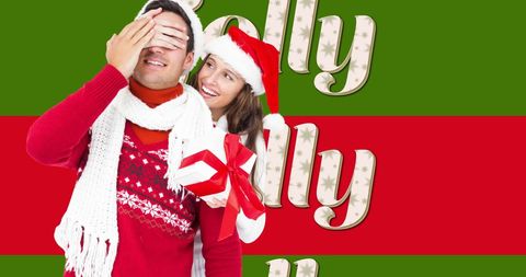 Happy couple celebrating christmas surrounded by festive jolly text