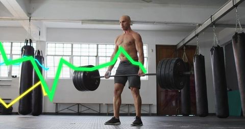 Muscular man deadlifting heavy barbell in industrial gym with neon performance graphs