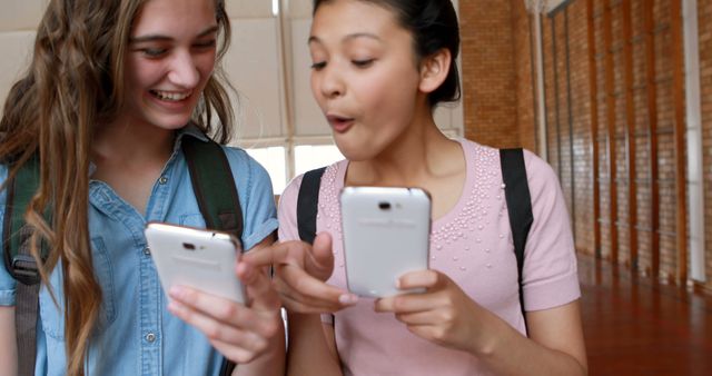 Teenage Girls Sharing Excitement Over Smartphone Screens at School - Download Free Stock Images Pikwizard.com