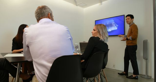 Diverse Team in Meeting with Presenter Using Presentation Monitor - Download Free Stock Images Pikwizard.com