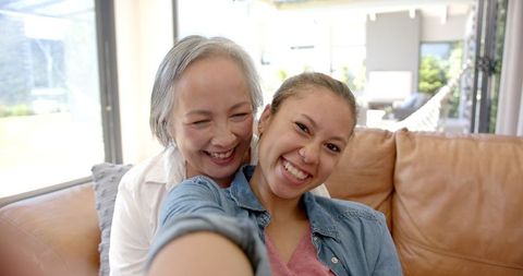 Happy Generational Bond Grandmother and Granddaughter Taking Selfie at Home