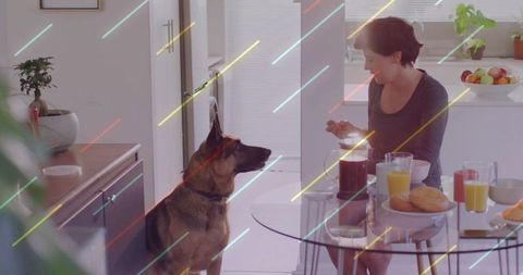 Woman Enjoying Breakfast with German Shepherd in Modern Kitchen