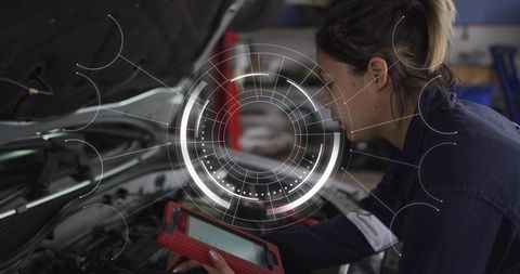 Female mechanic diagnosing car engine with tablet and digital diagnostic hud