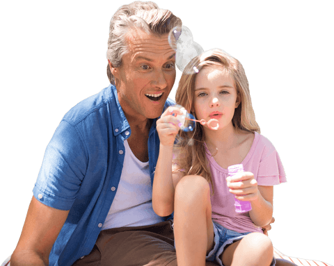 Transparent image of father and daughter blowing bubbles outdoors