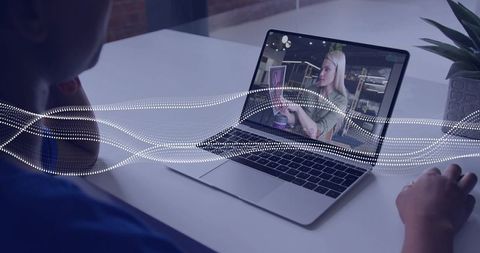 Remote presenter delivering live video on laptop with digital audio waveform overlay