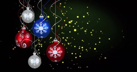 Festive christmas baubles with bokeh effect on green background