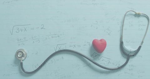 Stethoscope curving across pastel blue notebook with red heart and algebra notes study