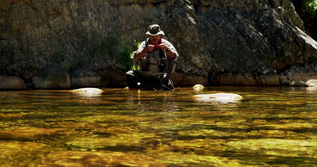 Backpacker enjoying fresh water from mountain stream in rugged landscape - Download Free Stock Images Pikwizard.com