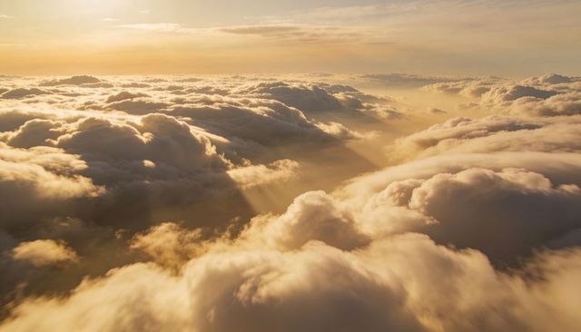 Sunrise Light Streaming Over Golden Cloudscape, Aerial View of Layered Cumulus Depth