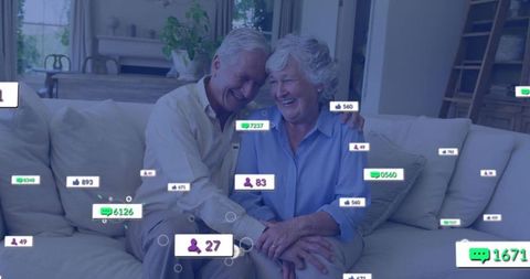 Smiling senior couple leaning on sofa surrounded by social media notifications