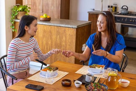 Mother and Daughter Bonding Over Meal in Cozy Kitchen Setting