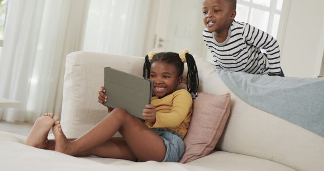 Happy African American Siblings Enjoying Tablet on Couch - Download Free Stock Images Pikwizard.com