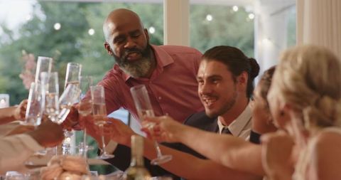 Man Giving Speech at Wedding Reception, Celebrating with Friends
