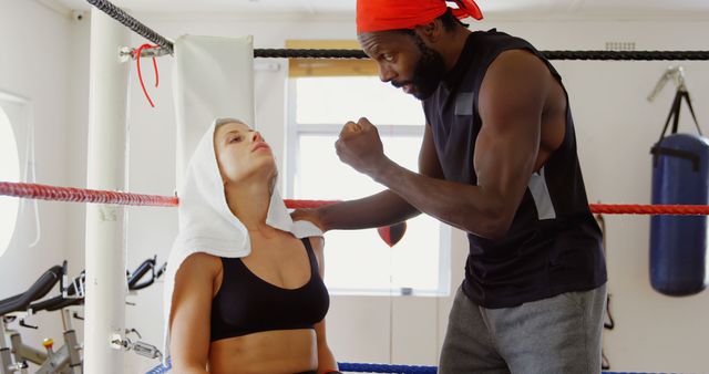 Motivated Female Boxer with Trainer in Boxing Ring - Download Free Stock Images Pikwizard.com