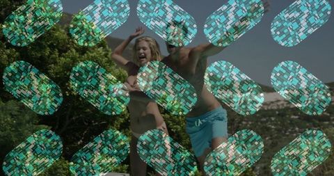 Carefree couples enjoying poolside jump on sunny vacation