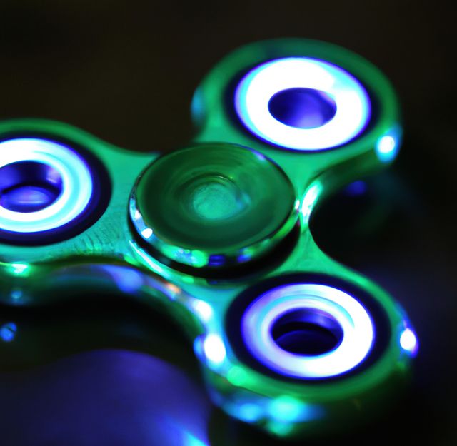 Image of close up of metallic fidget spinner on black background - Download Free Stock Photos Pikwizard.com