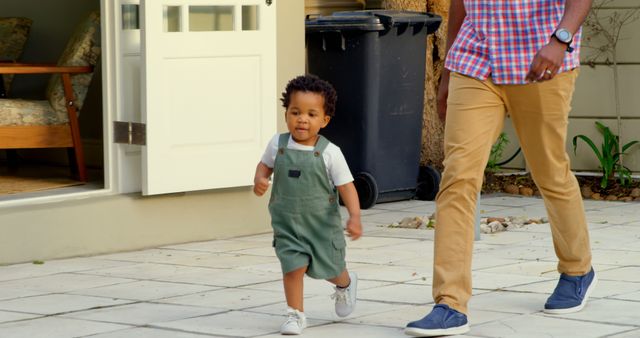 Father and young son walking together in backyard on a sunny day - Download Free Stock Images Pikwizard.com