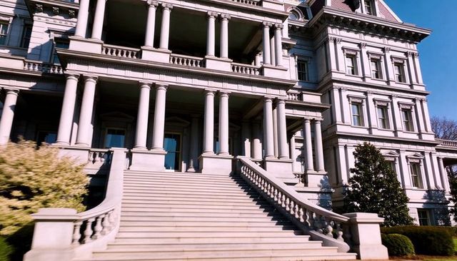 Grand neoclassical government building entrance featuring wide staircase, columned portico