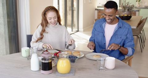 Happy Couple Enjoying Pancake Breakfast in Sunlit Home