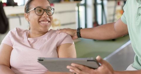 Smiling Woman Engaging in Rehabilitation Therapy with Supportive Guidance