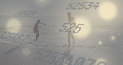 Couple enjoying beach with numeric digital overlay