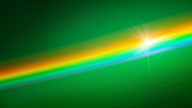 Diagonal rainbow light beam crossing green gradient background with white starburst