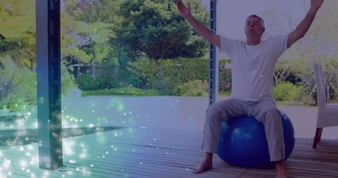 Senior Man Meditating on Yoga Ball with Light Effects