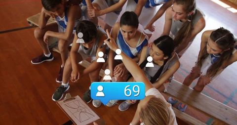 Basketball coach motivating young players on team strategy