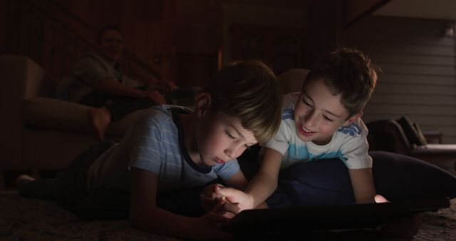 Young Boys Playing on Tablet at Home in Evening Light - Download Free Stock Images Pikwizard.com