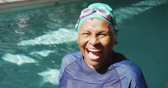 Elderly woman enjoying a swim outdoors, radiating happiness and confidence. Perfect visual for promoting healthy lifestyles and active living among seniors, recreational activities at the swimming pool, or summer fun. Useful for health and wellness campaigns, advertisements for swimwear and goggles, or articles about the benefits of swimming for the elderly.