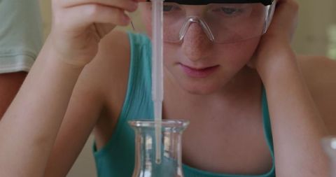 Young Girl Conducting Chemistry Experiment with Pipette