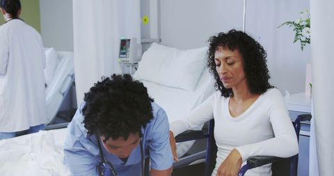 Mother and Nurse Discussing Aftercare in Hospital Room