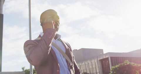 Confident African American Businessman Using Smartphone Outdoors