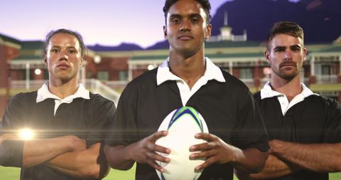 Diverse rugby players standing in sports stadium
