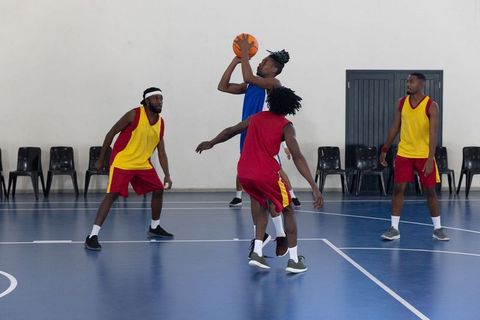 Basketball Players Competing Intense Game on Indoor Court