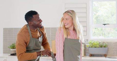 Joyful Couple Preparing Meals in Home Kitchen