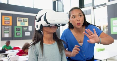 Teacher Guiding Student Wearing VR Headset in Classroom Activity