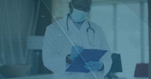 Senior Physician Writing Prescription in Modern Clinic