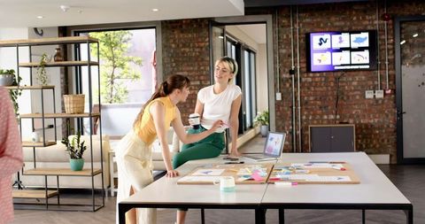 Female Professionals Collaborating in Modern Loft Office